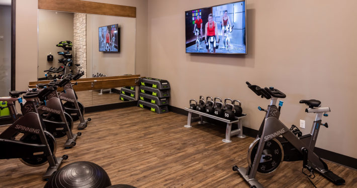Group fitness studio with wellbeats, kettlebells and spin bikes